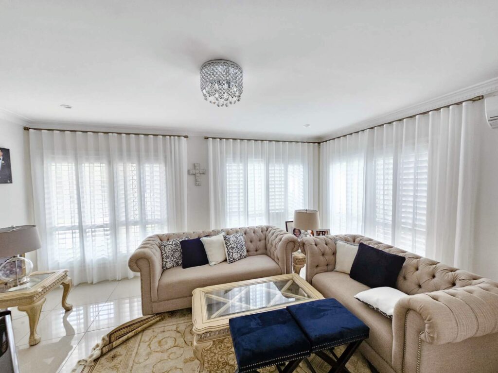 S-fold privacy sheers installed on rod track in living room.