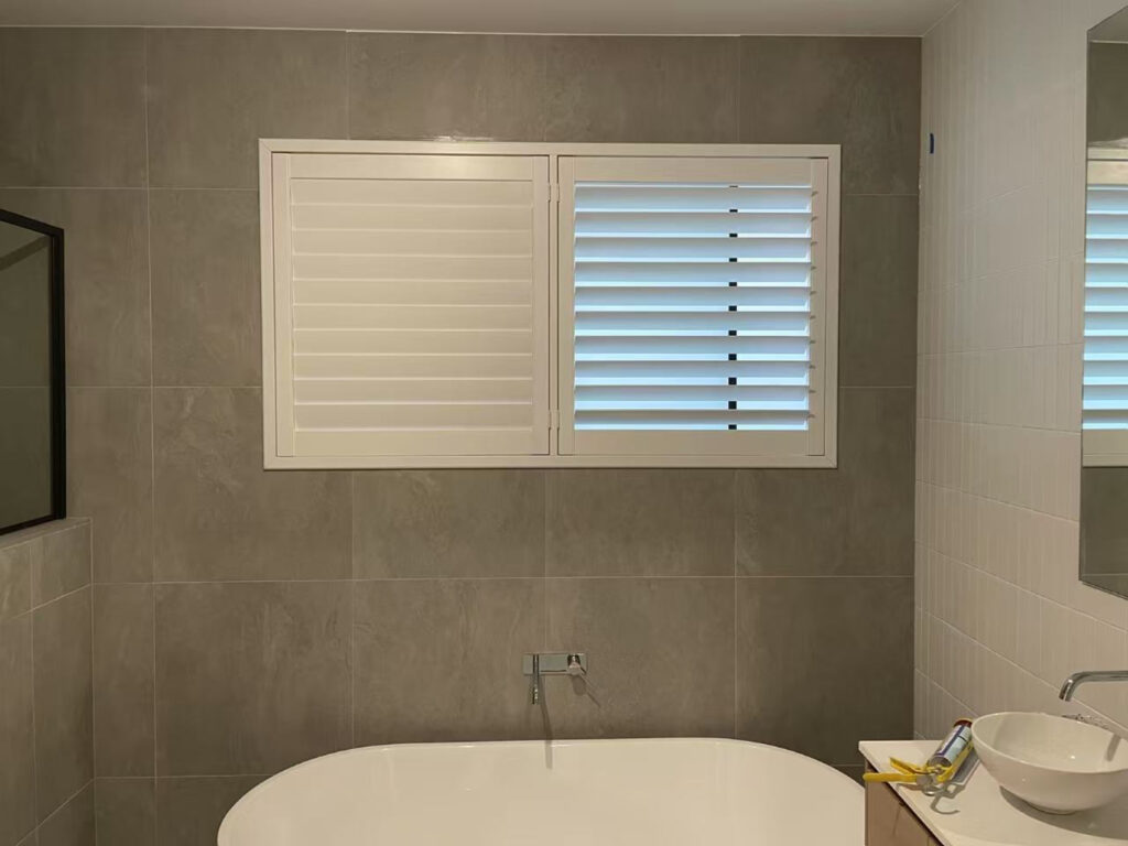2 pvc plantation shutters installed for one window in the bathroom