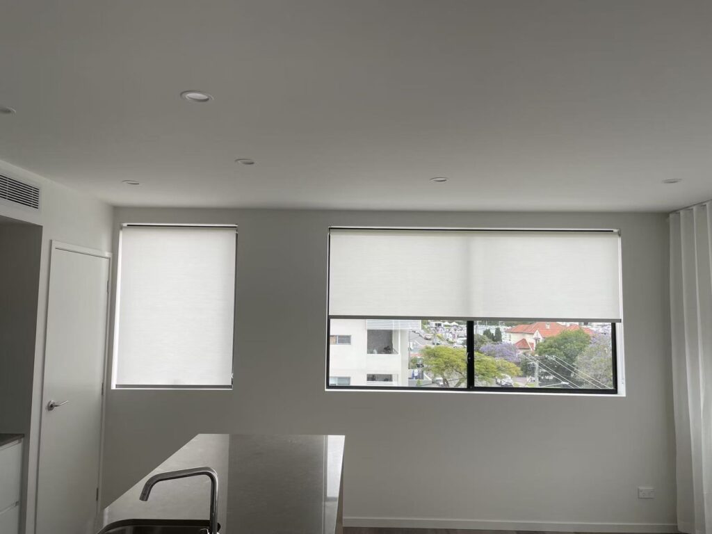 2 windows installed with white filtering privacy roller blinds in the kitchen