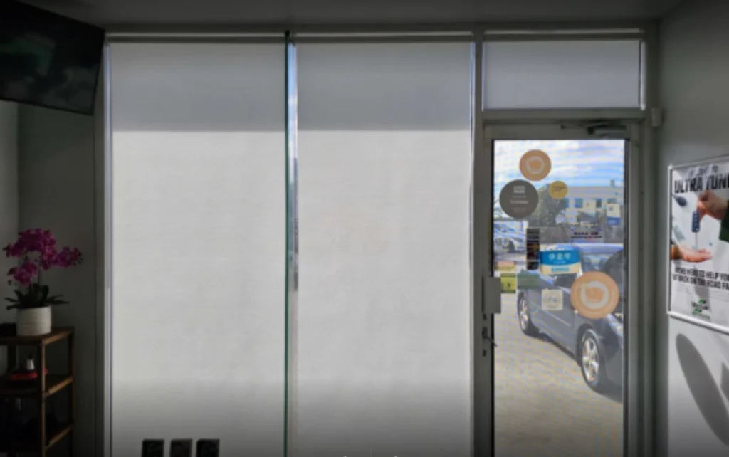 3 white light filtering privacy roller blinds installed in entry