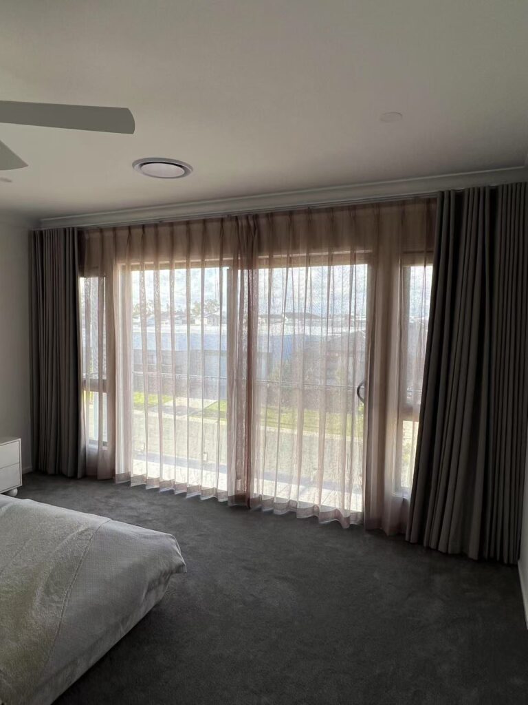 brown s fold blockout curtain and pinch transparent sheer installed in the master bedroom