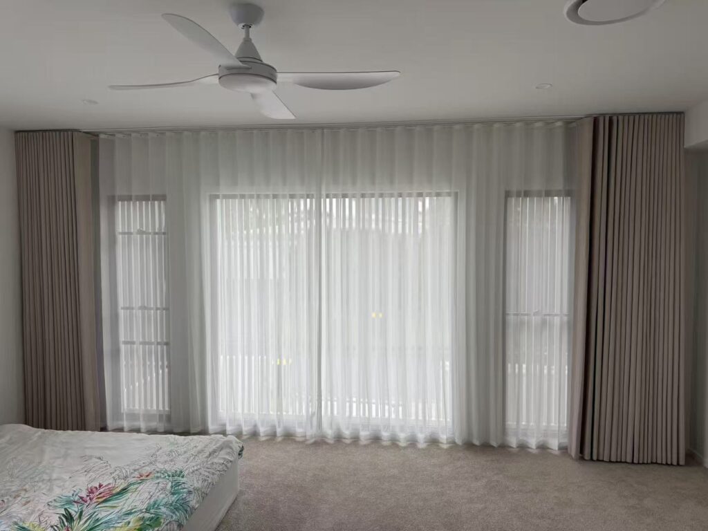 full wall s fold curtain with s fold transparent sheer installed in master bedroom