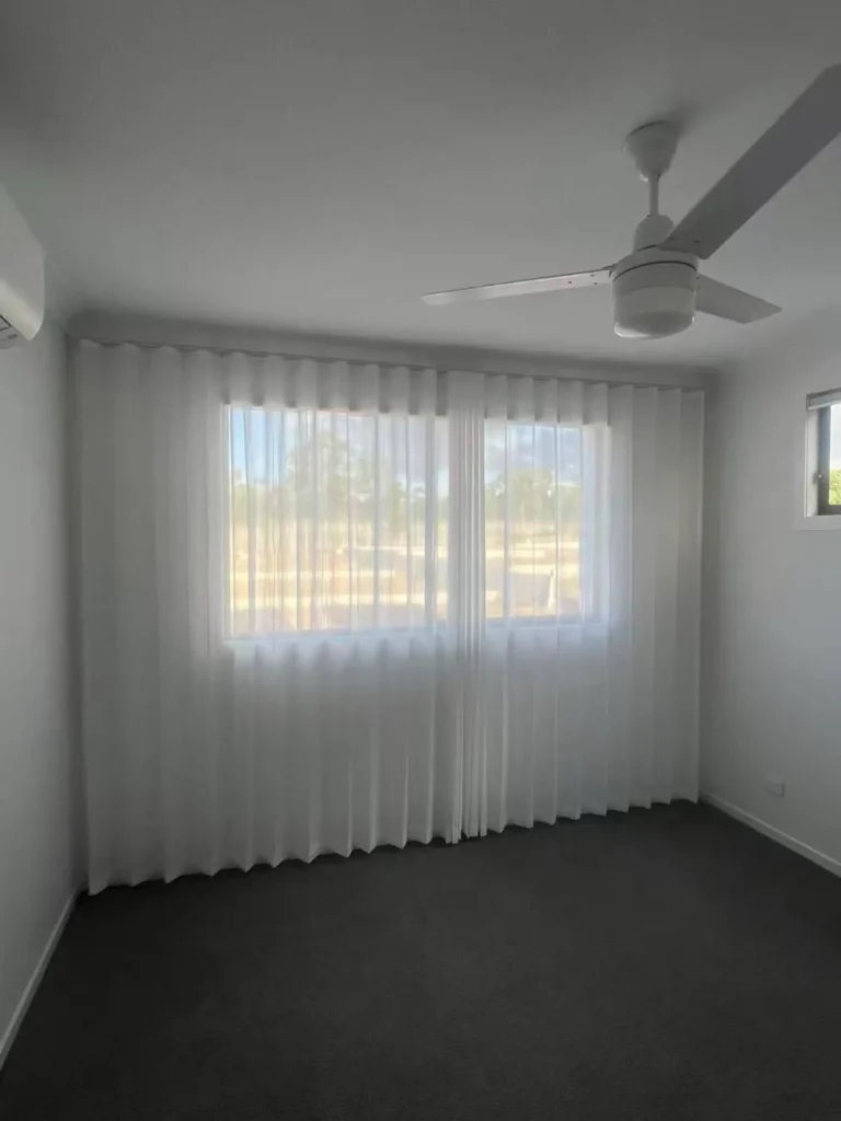 full wall s fold transparent sheer installed in bedroom