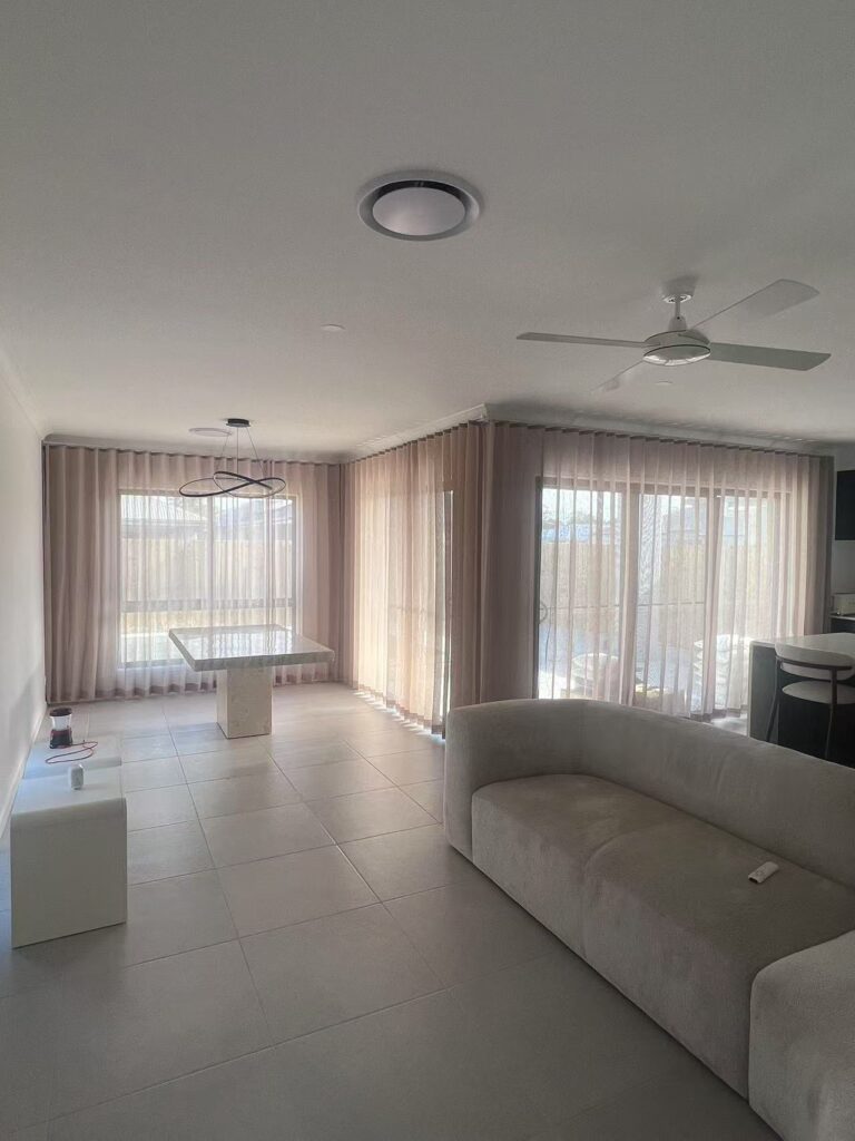 light brown s fold sheer installed for living room window and sliding door