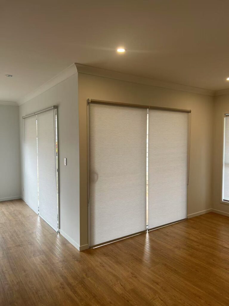light filtering privacy grey roller blinds installed for two sliding doors in alfresco area using reverse way to install