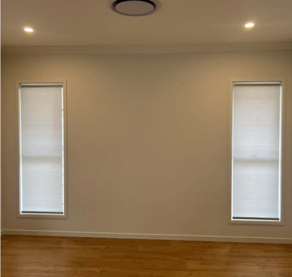 light filtering privacy roller blinds installed for two windows in living area