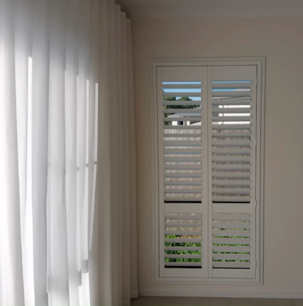 pvc plantation shutter and s fold sheer installed in bedroom