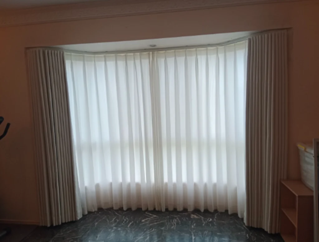 s fold blockout curtains and pinch privacy sheer installed for the bay windows