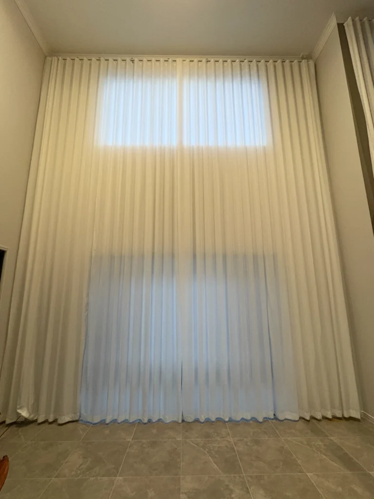 s fold privacy sheer installed for high window in living area