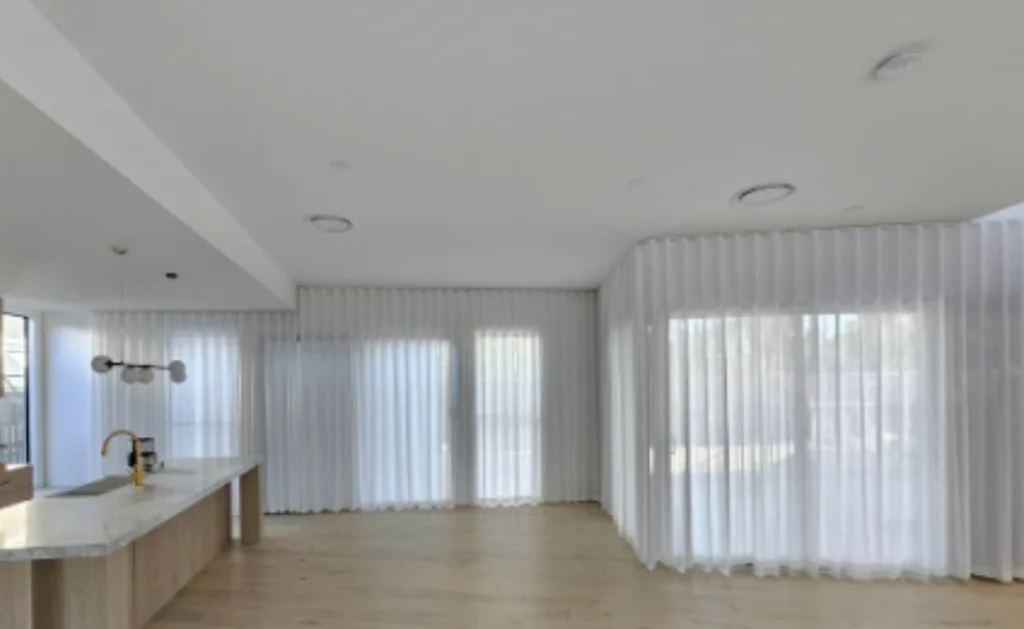 s fold transparent sheer installed for sliding doors and windows in kitchen and living area