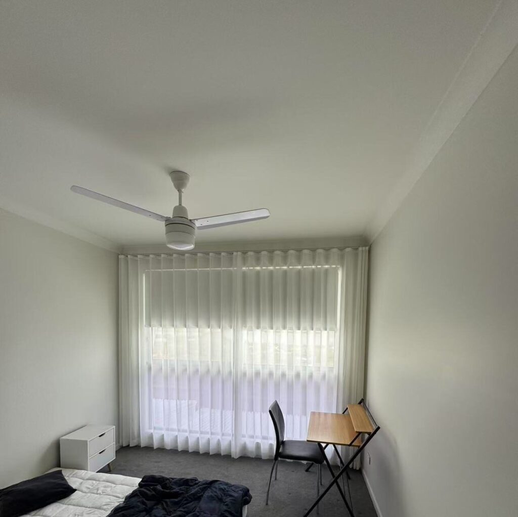 s fold transparent sheer with grey blockout roller blind installed for bedroom window