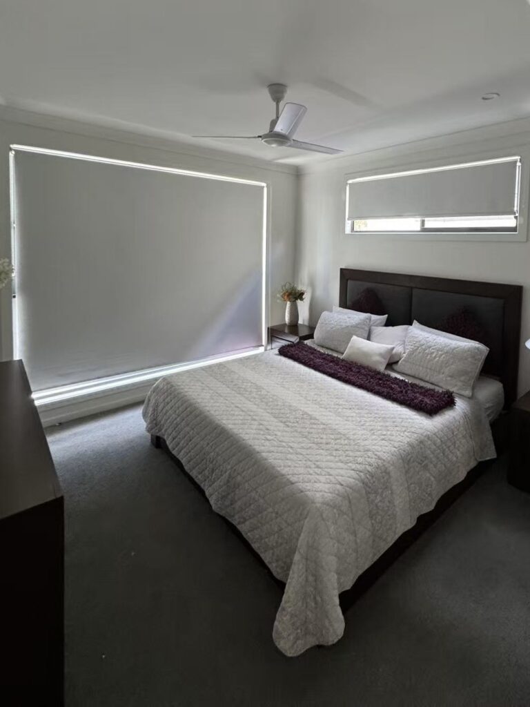 white blockout roller blinds installed in the bedroom