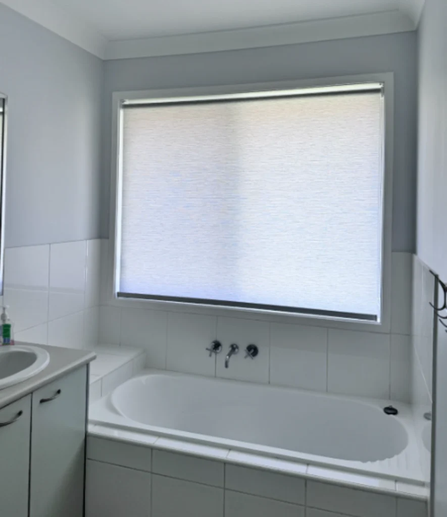 white light filtering privacy roller blind installed in bathroom