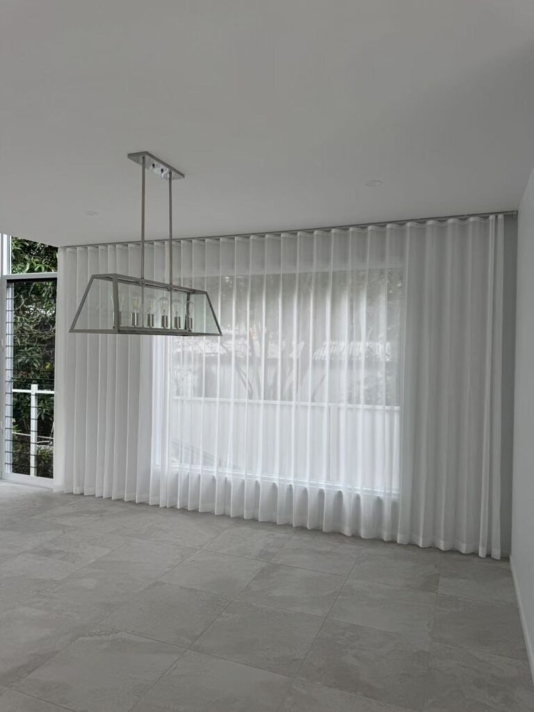 s fold transparent sheer installed full wall width in living area